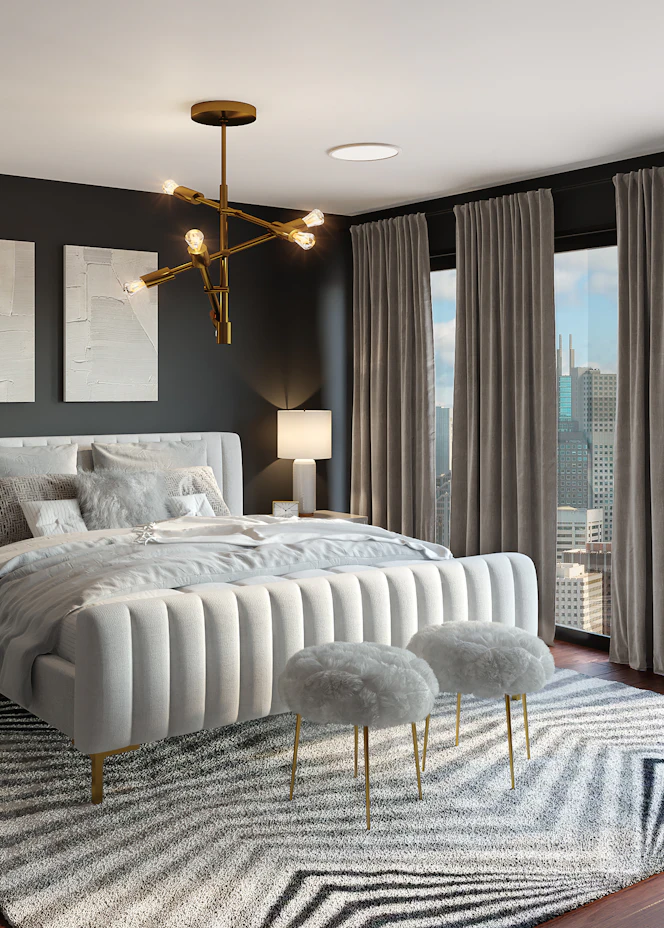Bedroom with an upholstered bed and gold chandelier – The Design Organization