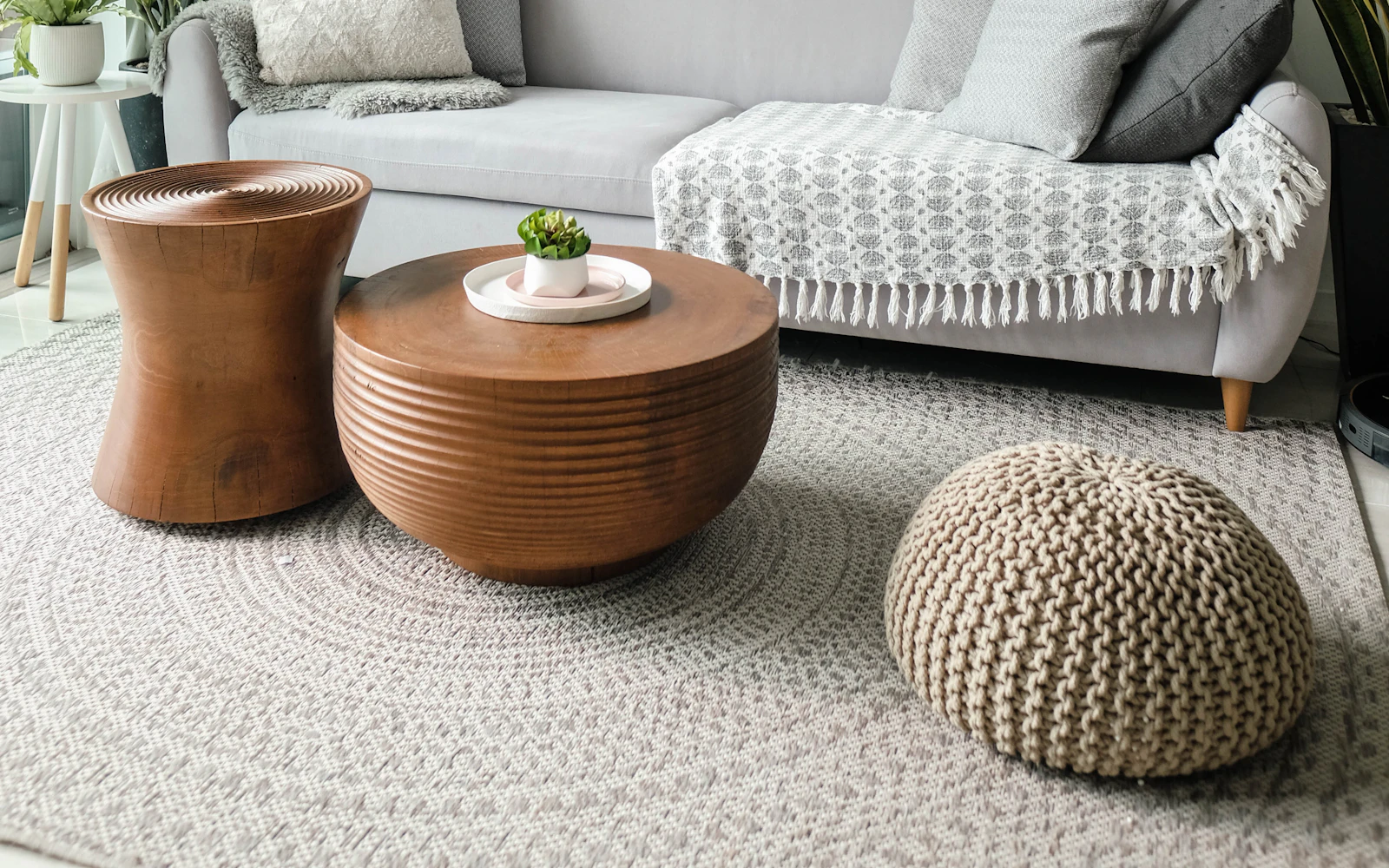 Living room with a grey sofa and wooden side tables – The Design Organization