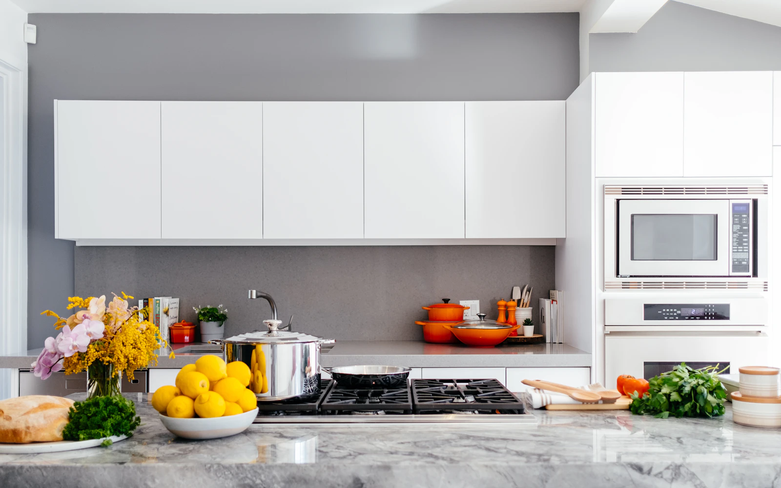 Modern white kitchen with a marble island – The Design Organization